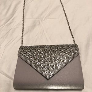 Jessica McClintock silver clutch with metal chain.